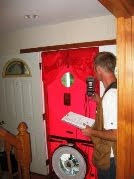 Red fire safety station with emergency equipment mounted on wall indoors.