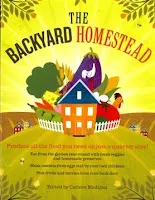 Colorful illustrated cover of "The Backyard Homestead" book featuring a red house surrounded by vegetables and nature.