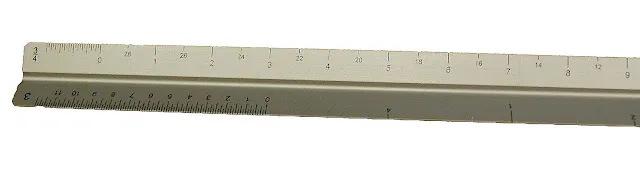 Metal ruler showing measurement markings in inches and centimeters on white background