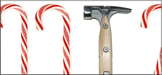 Hammer surrounded by red and white candy canes on white background