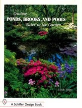 Garden book cover showing colorful flowering plants near water and lush green foliage