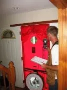 Red fire safety station with emergency equipment mounted on wall indoors.