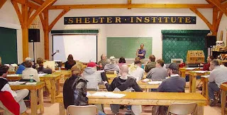 Diverse students studying together in a wooden-beamed classroom with green chalkboards and Shelfer Institute signage.