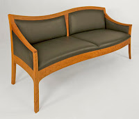 Modern wooden sofa with gray upholstered seat and back cushions