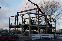 Industrial metal frame structure on wheels against cloudy sky and bare trees