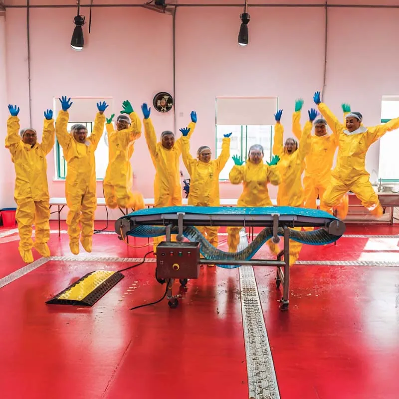 people wearing yellow PPE jumping