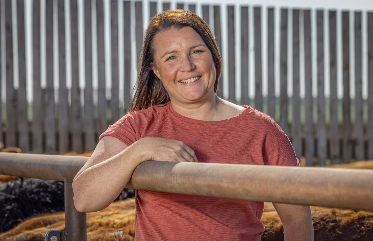 Woman standing and smiling in a farm
