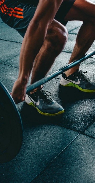 A person squats with a barbell during a CrossFit session at CrossFit 812 in Vincennes, IN.