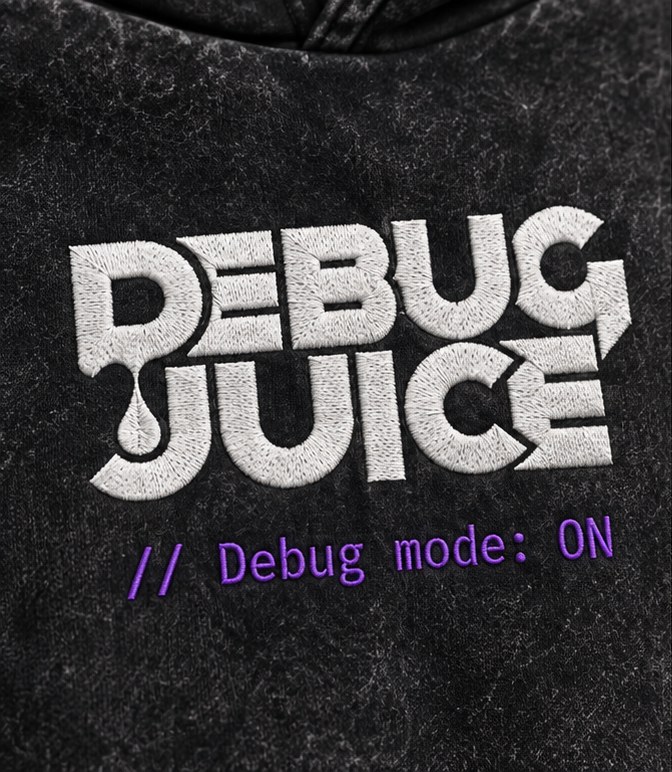 Close-up of the white satin DEBUG JUICE wordmark on the chest