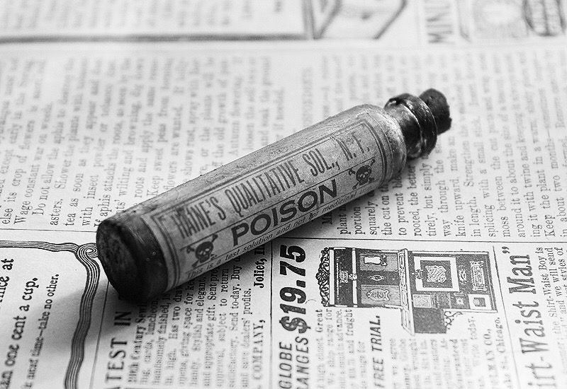 Poison vial on newspaper