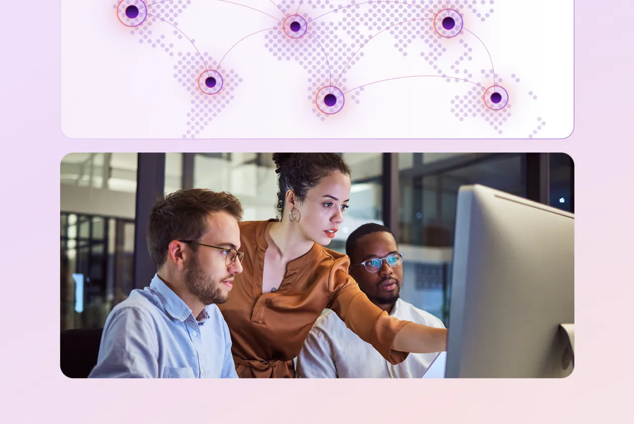 Three diverse colleagues collaborating and looking at a computer screen in an office setting.