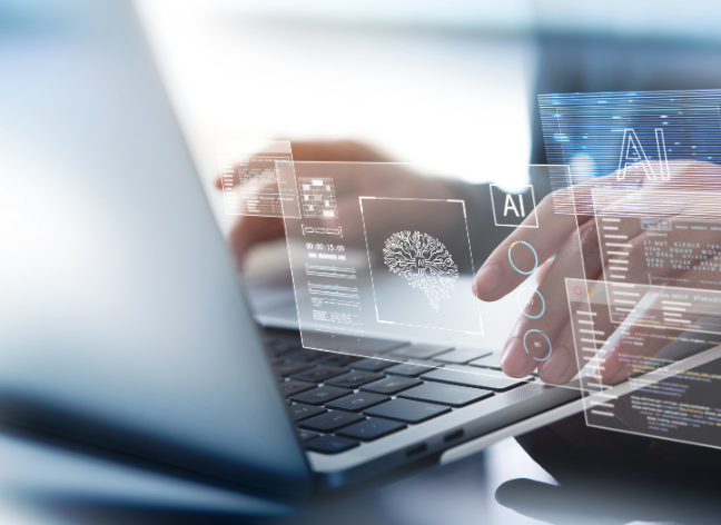 Hands working on a laptop with artificial intelligence interface graphics, symbolizing innovation and AI-powered digital solutions.