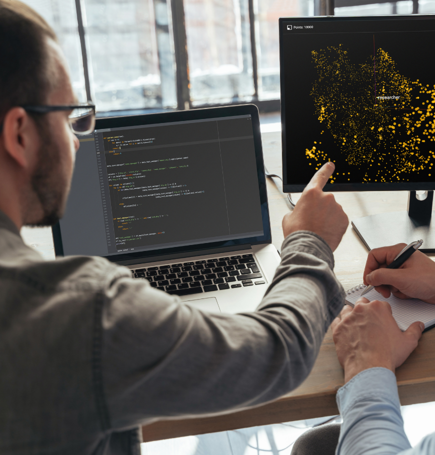Closeup of two men data science specialists working at office together, analyzing big data on screen. Coders working on new project