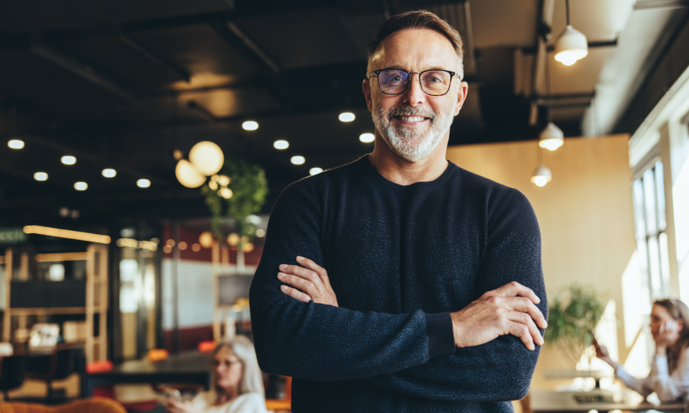 Businessman standing in a tech co-working space