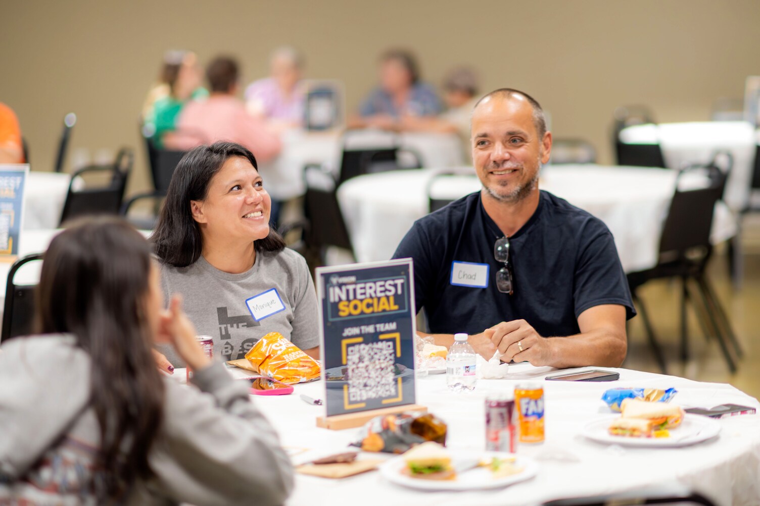 A family at a social event for Vision Church, sitting at a round table