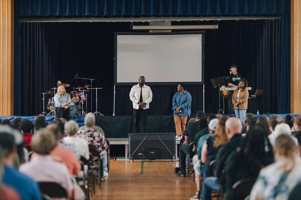 A pastor standing on a stage preaching
