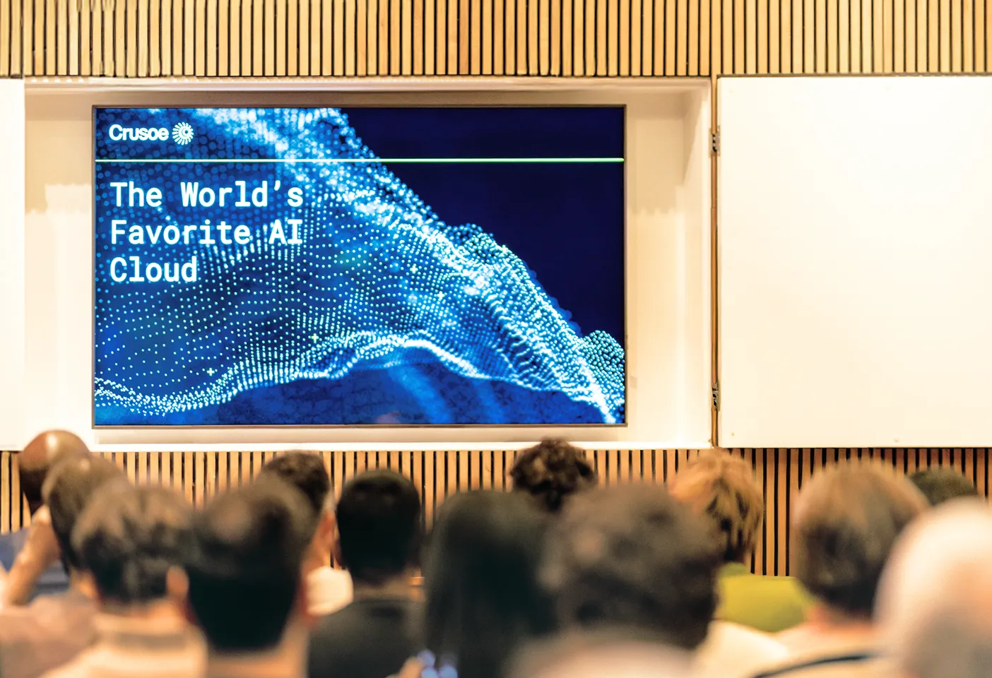 Audience facing a screen displaying 'The World's Favorite AI Cloud' with digital wave graphics.