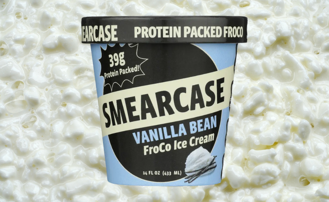 A pint of vanilla bean flavored Smearcase FroCo with a cottage cheese background behind it