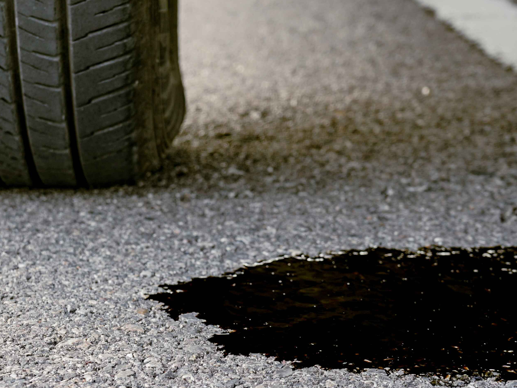 Fluid leaking from under vehicle parked on driveway – local auto repair service Lake Elsinore