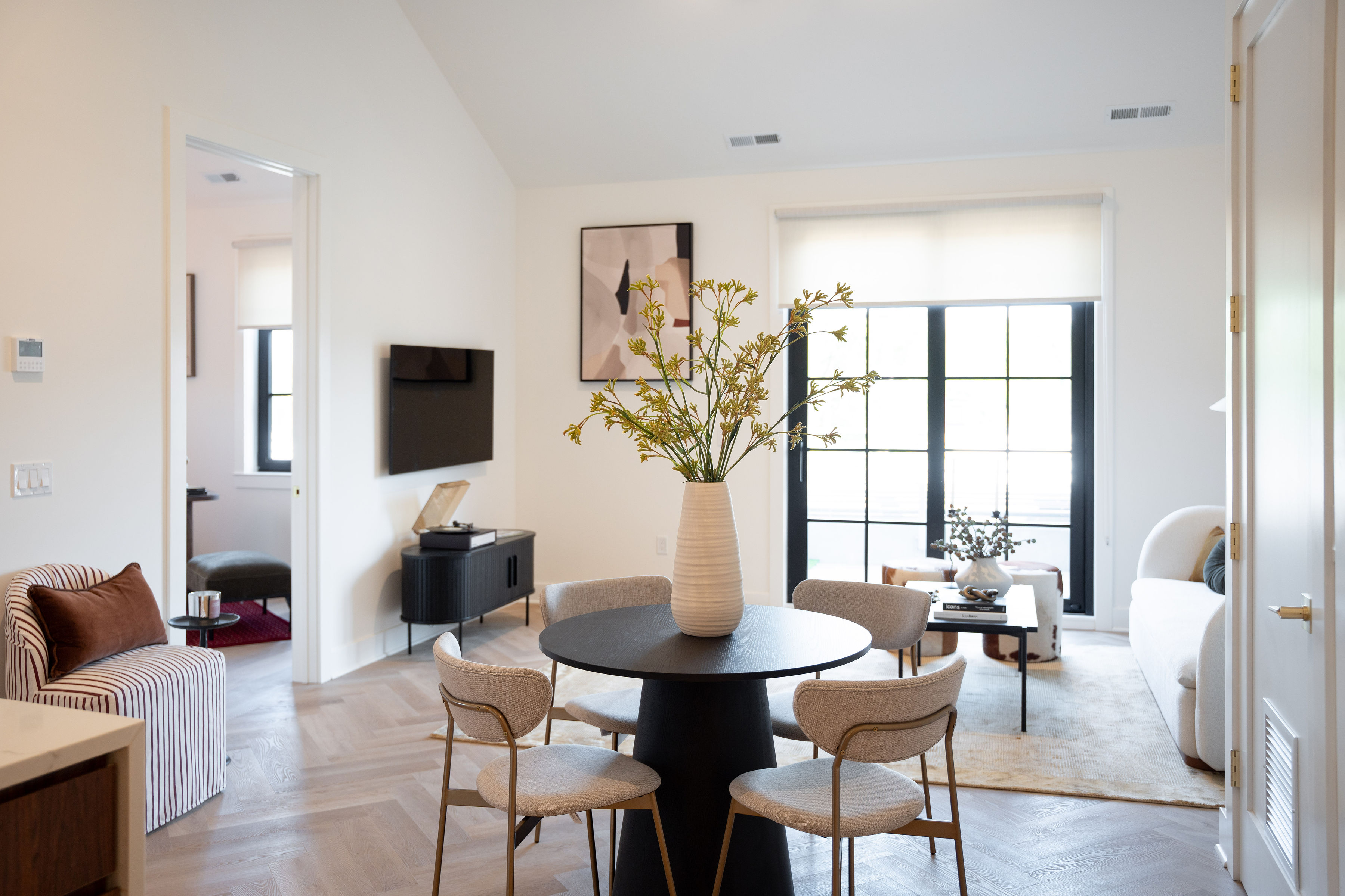 Living area at 100 East Putnam in Greenwich, CT, with seating and views through oversized windows.