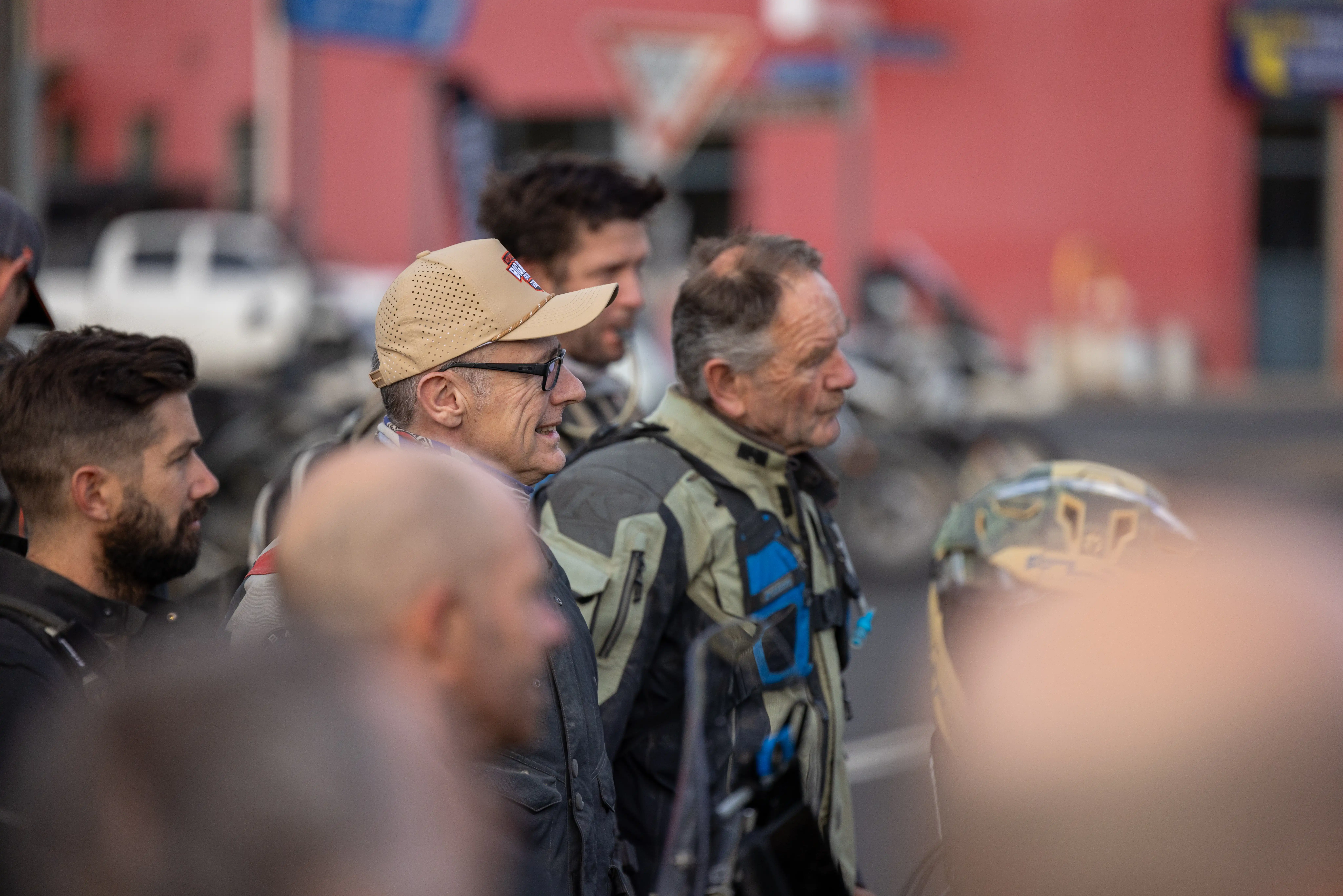 A group of motorcycle riders listening to directions