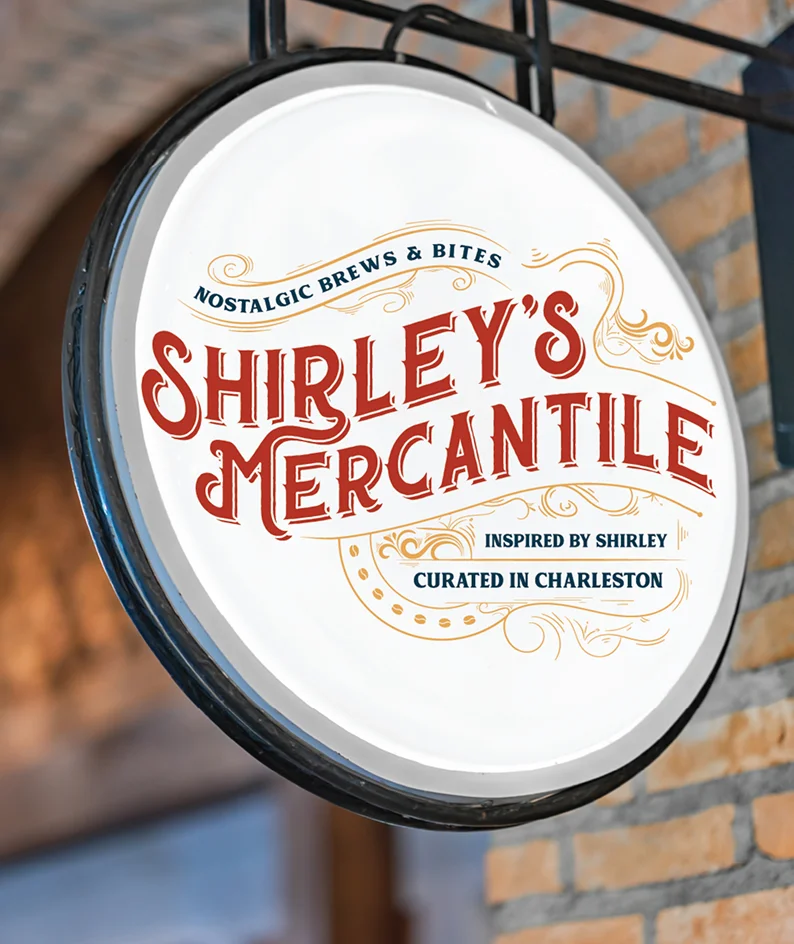 Exterior hanging sign for Shirley’s Mercantile showcasing vintage-inspired logo and storefront signage design