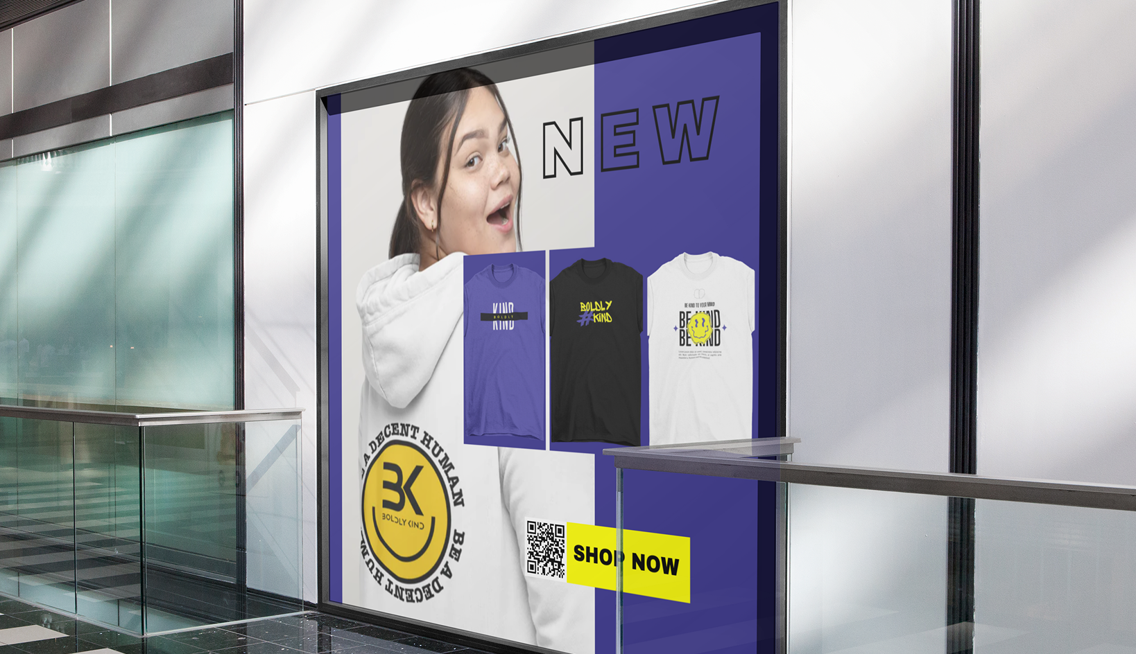Retail storefront window featuring Boldly Kind Apparel branding and messaging promoting kindness-driven fashion