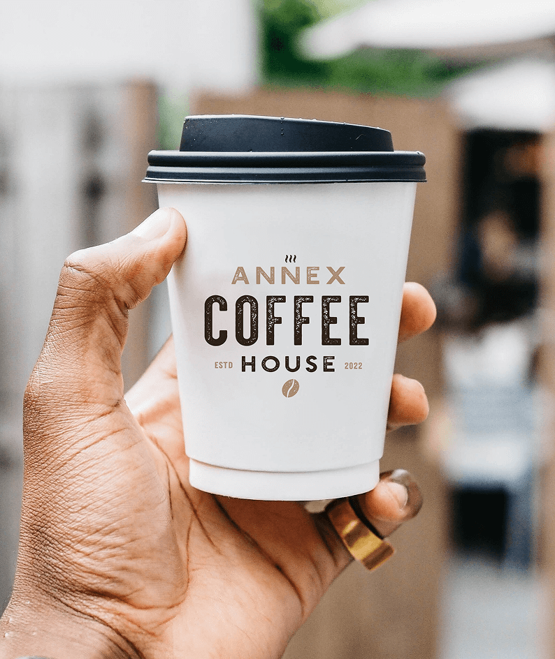 Branded to-go coffee cup for Annex Coffee House featuring minimalist logo and cozy cafe vibes