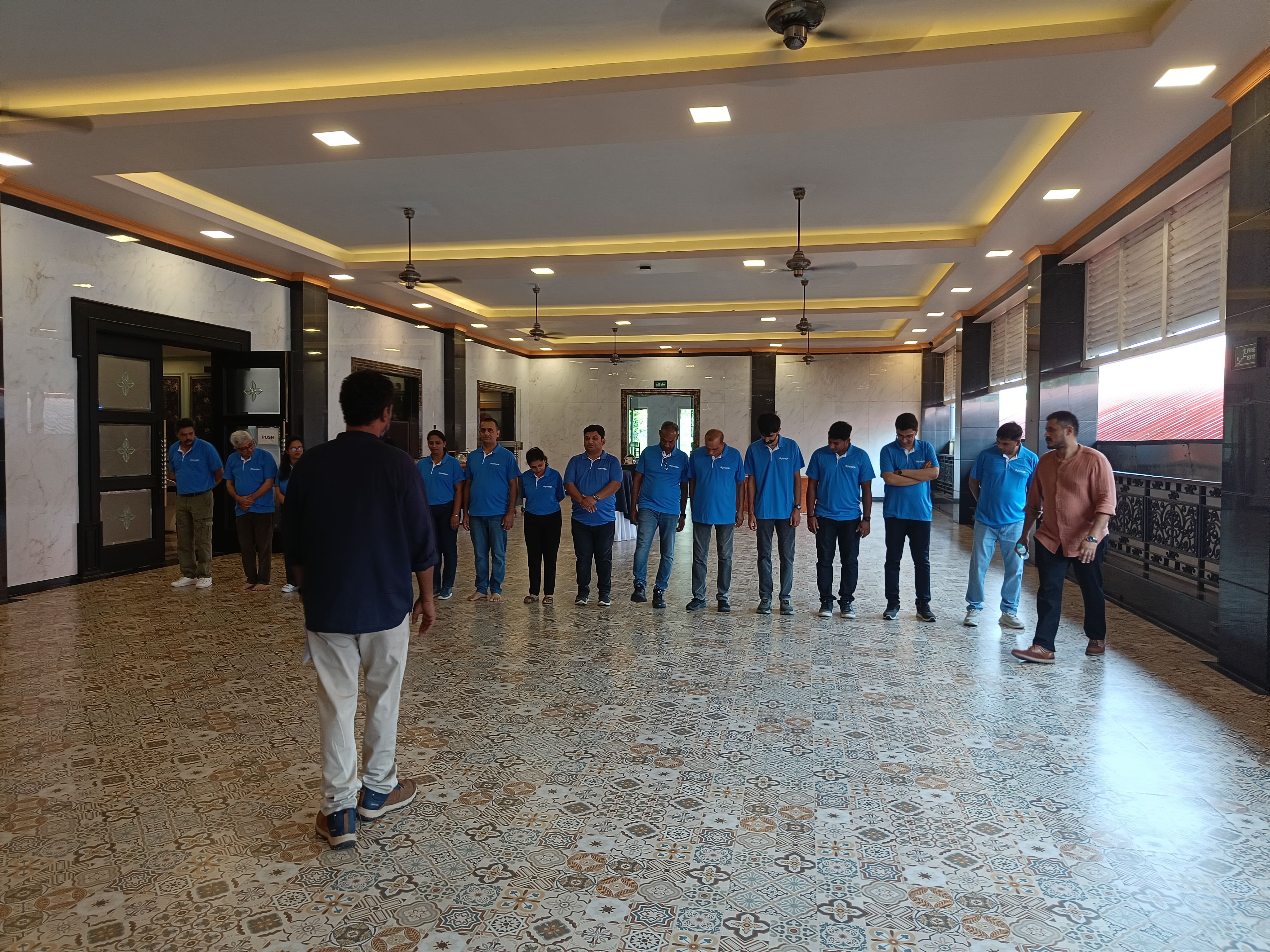 Digiyatra participants in a guided group exercise indoors