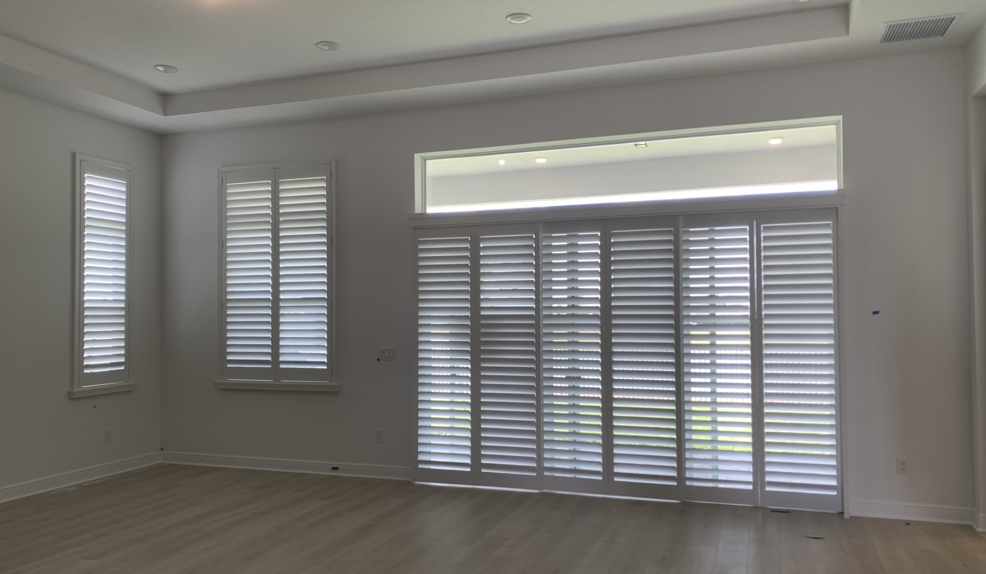 Custom white wood plantation shutters in a living room