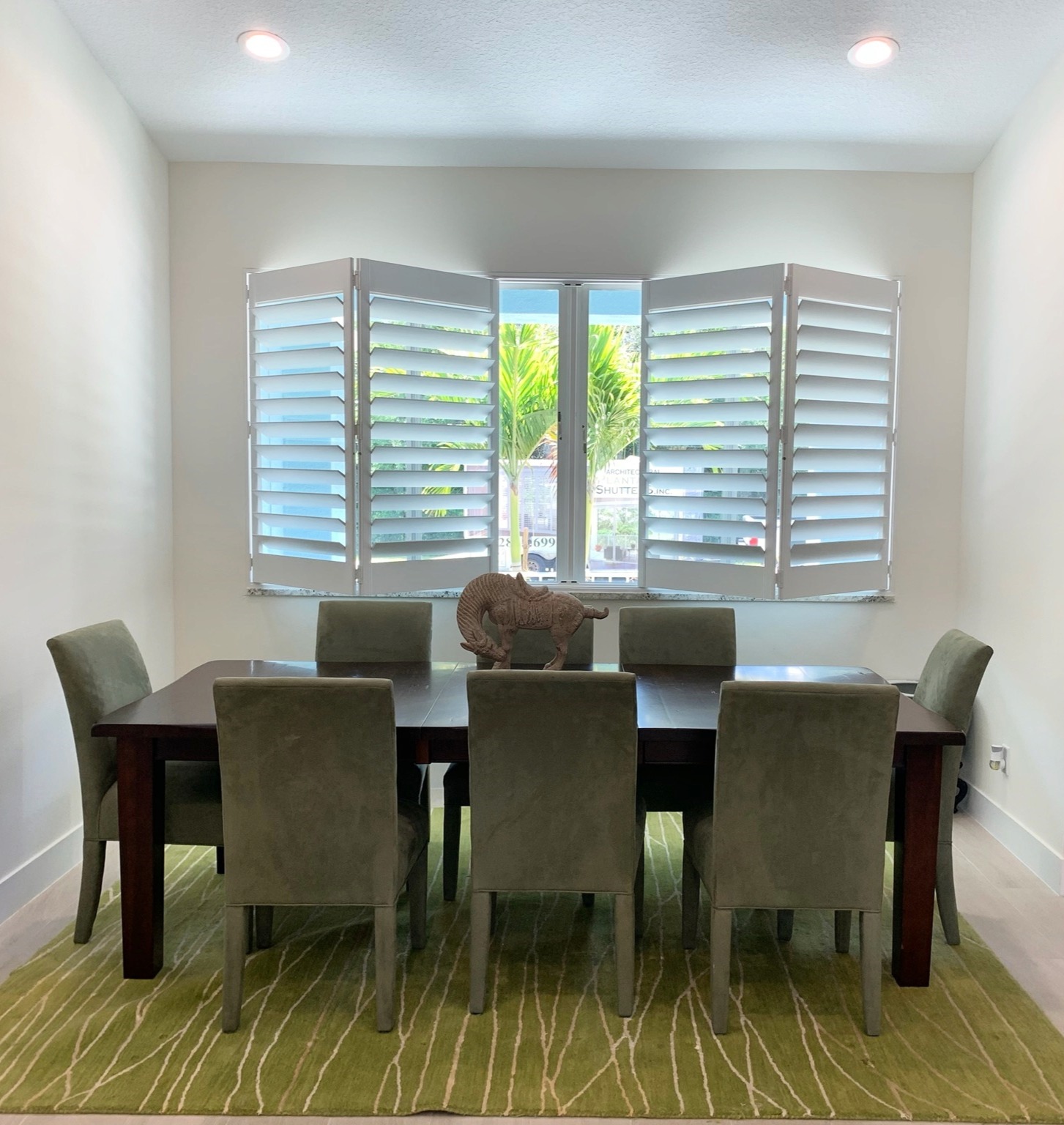 Sample custom wood shutters in dining room