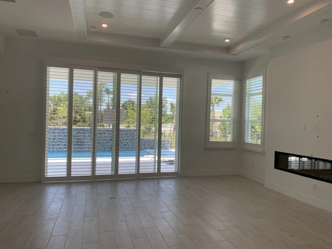 Bypass sliding-door real-wood plantation shutters on a glass slider in a Palm City, FL home