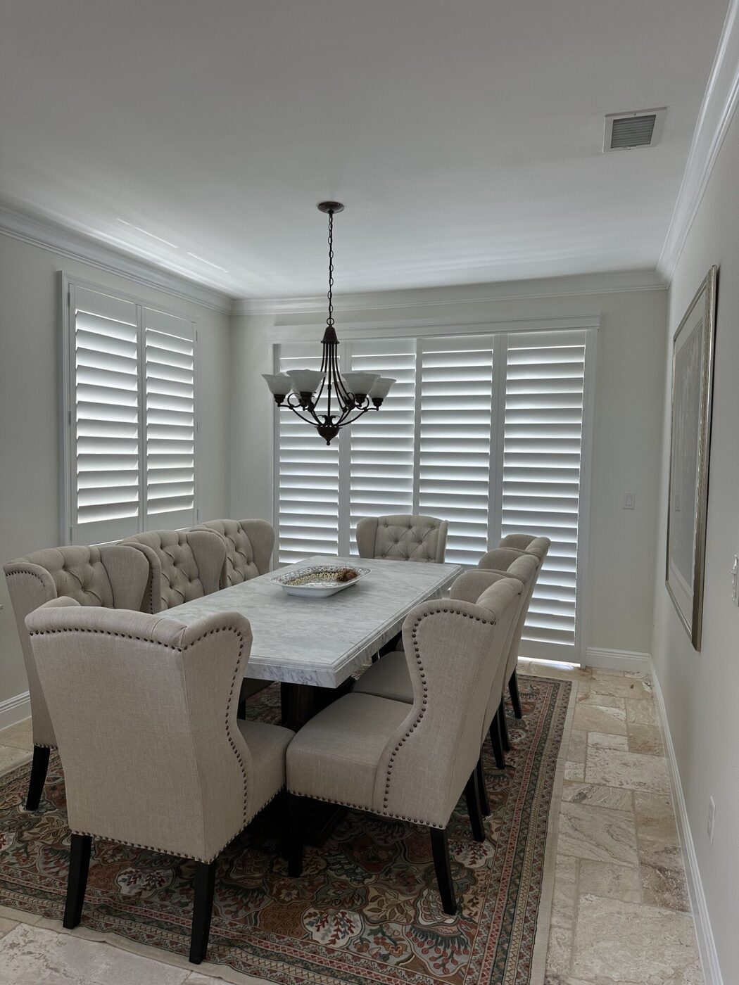 Custom real-wood plantation shutters in a formal dining room of a new-construction Port St. Lucie home near Riverland