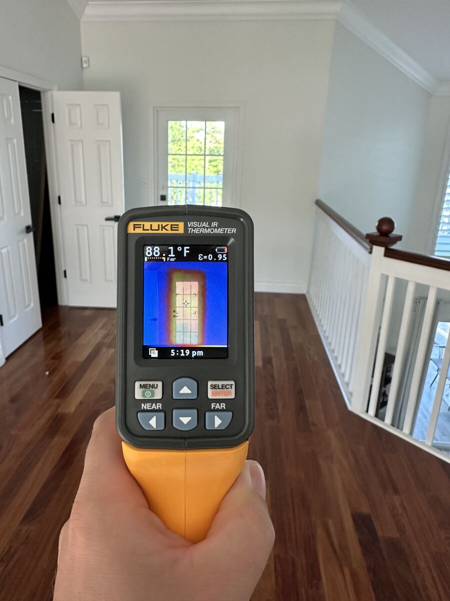IR thermometer reading 88.1°F on bare French door glass in Martin County home