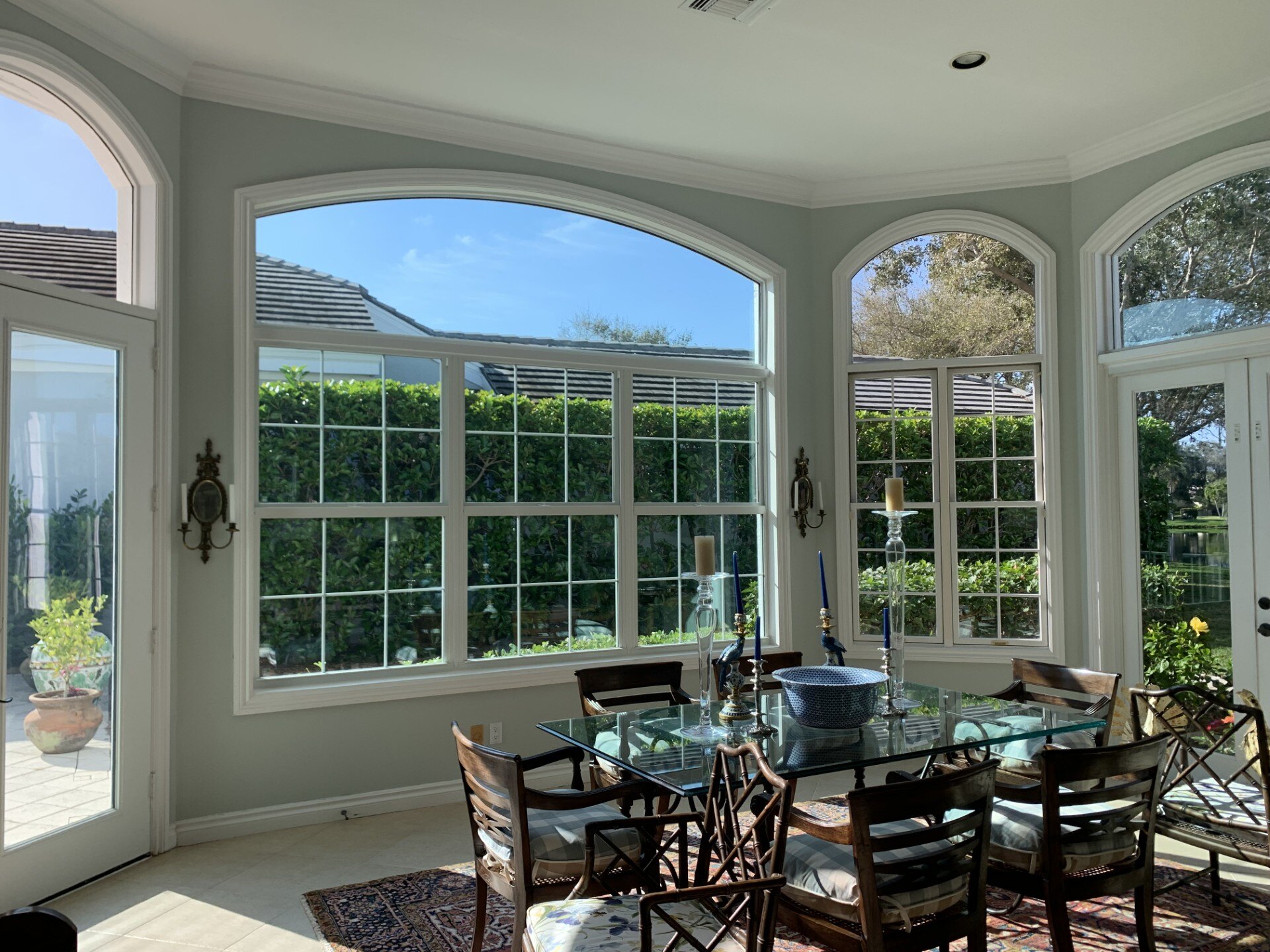Stuart, FL dining room with bare arched windows before plantation shutters were installed