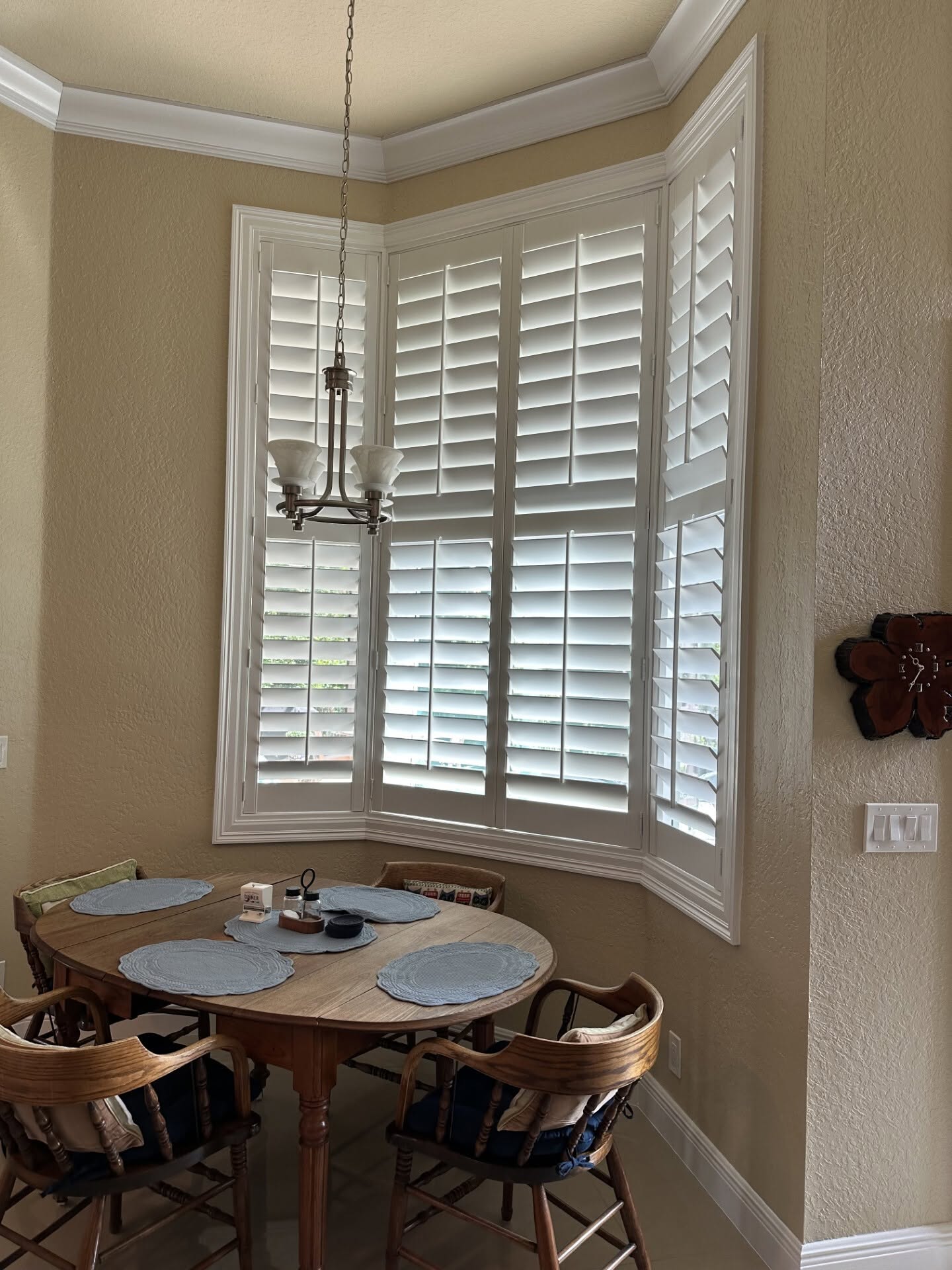 After: custom real-wood plantation shutters installed on a kitchen bay window near Jensen Beach, FL