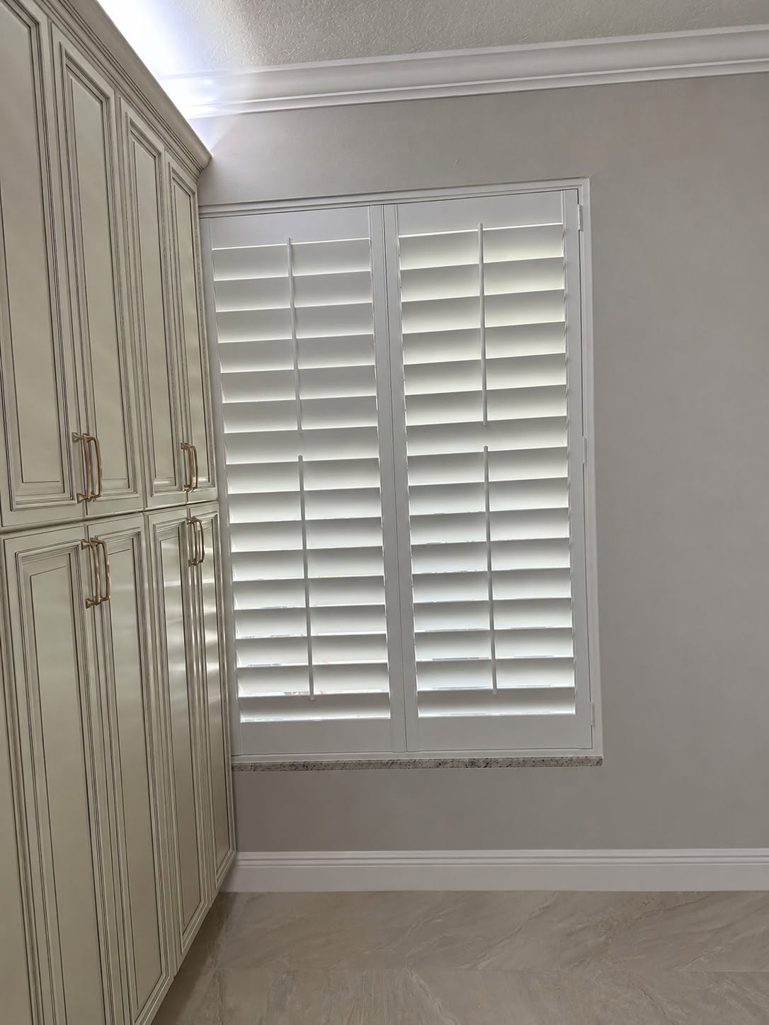Custom real-wood plantation shutters fitted to a tricky specialty kitchen window in Port St. Lucie, FL