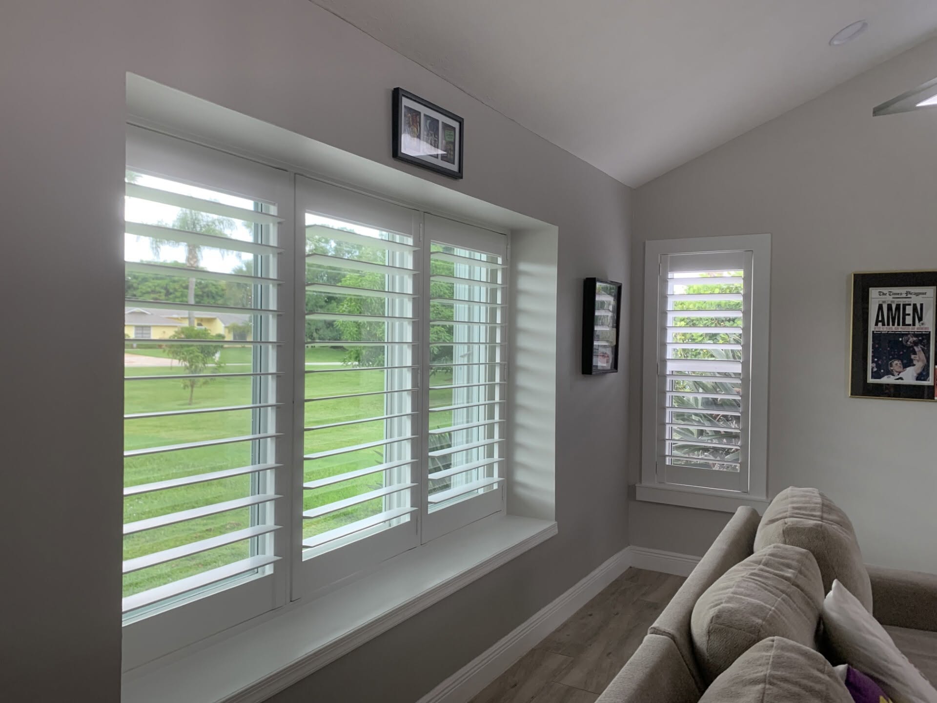 White real-wood plantation shutters installed in a Port St. Lucie living room