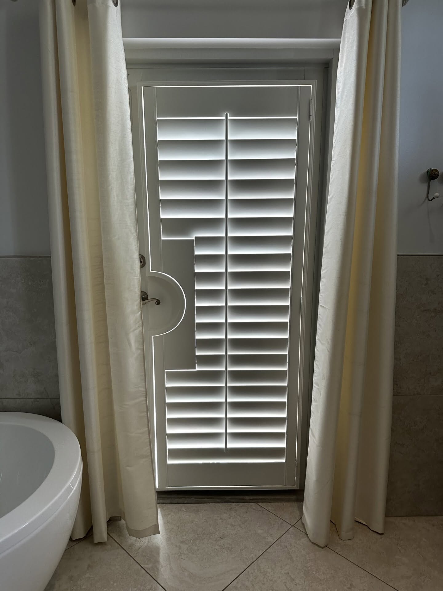 Real-wood plantation shutters in a Sewall's Point, FL cabana bath