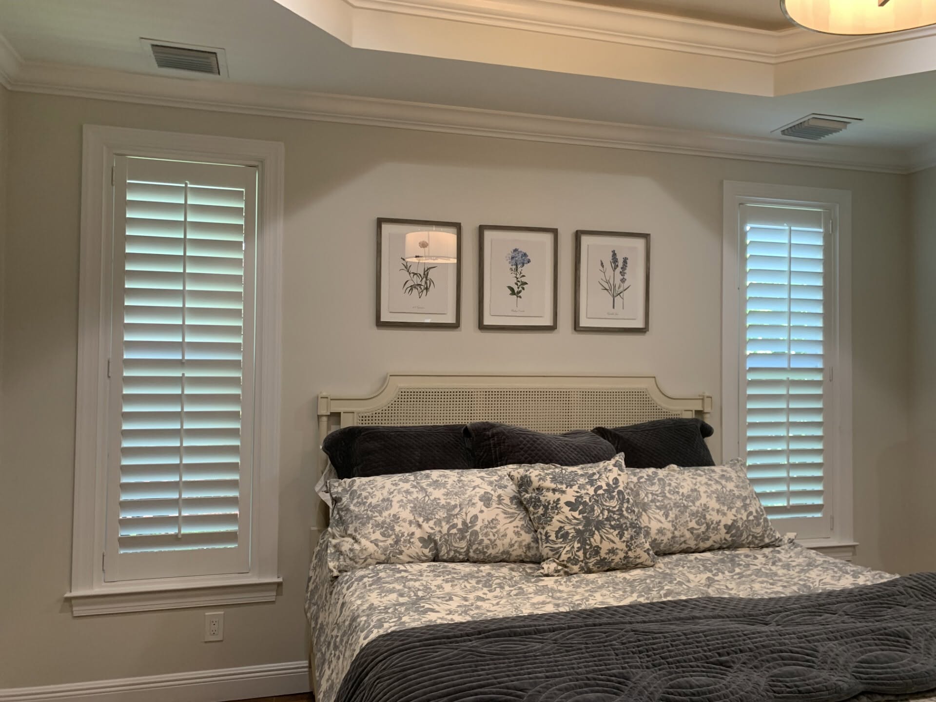 Real-wood plantation shutters in a coastal master bedroom near Hobe Sound, FL