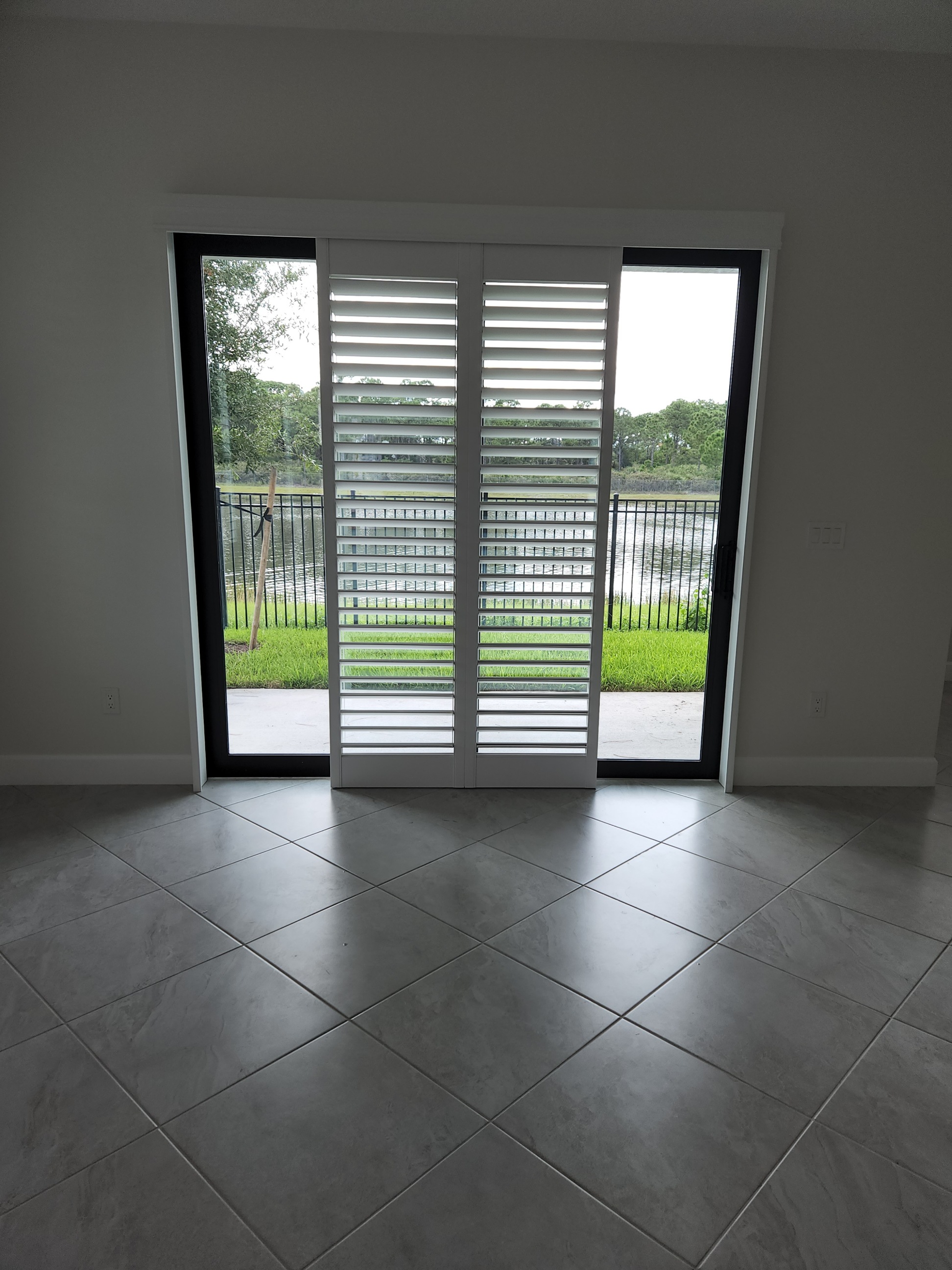 Two front white shutter faces gathered centrally with glass exposed on both sides