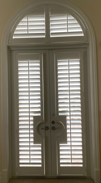 Separate half-round louvered arch above French door shutters