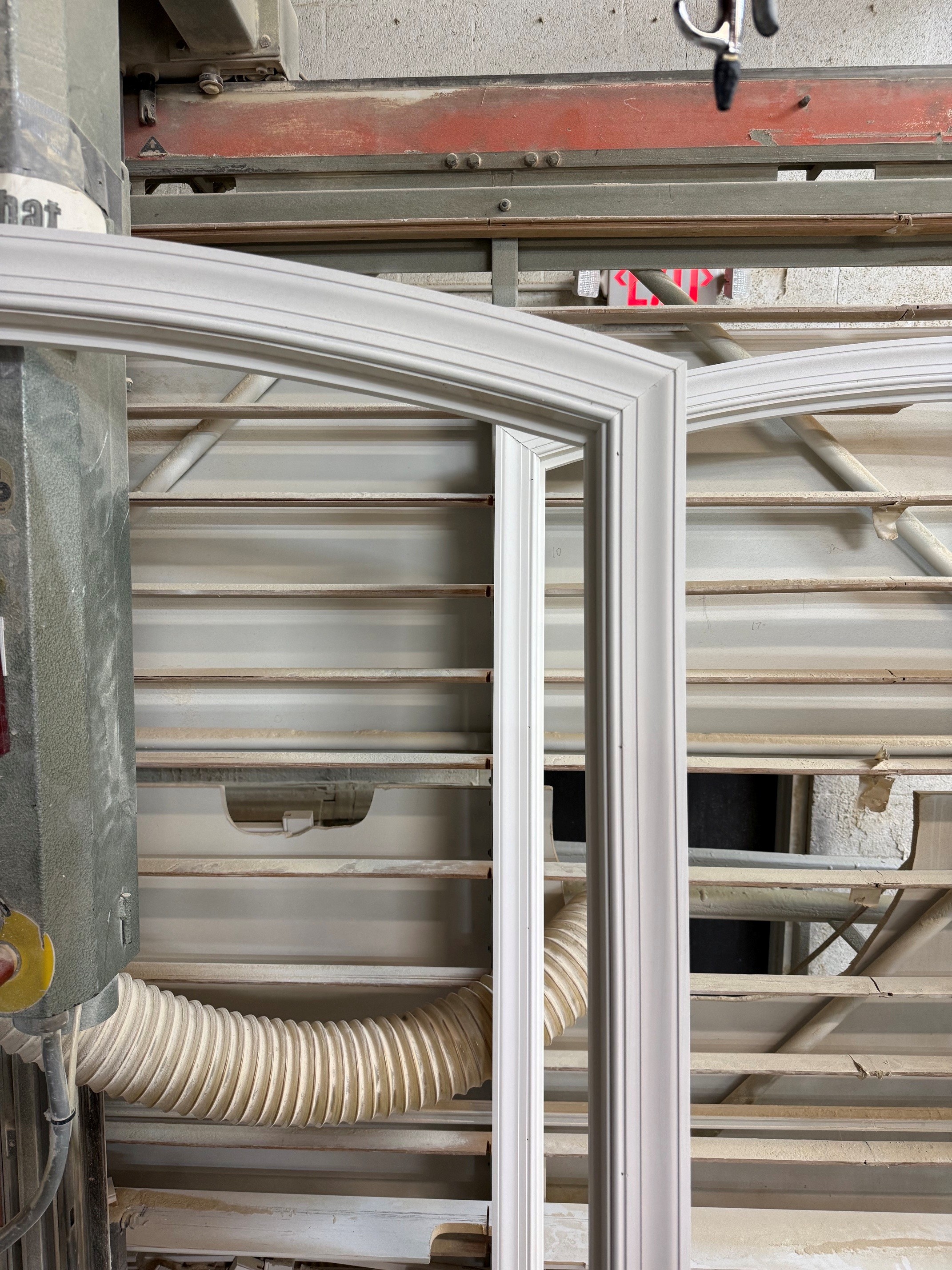 Decorative curved shutter frame profiles on a workshop rack