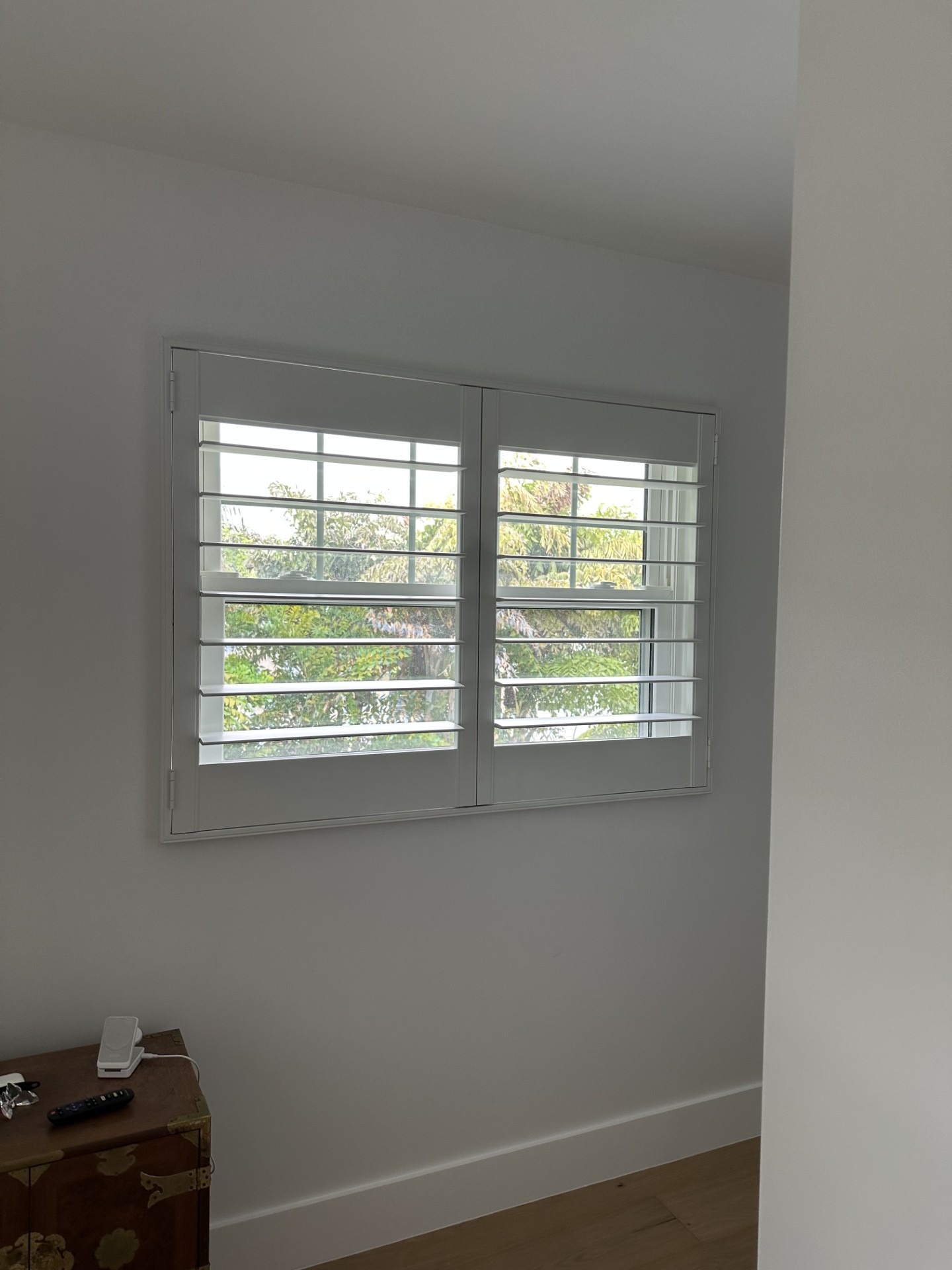 APS wood shutters across bedroom windows