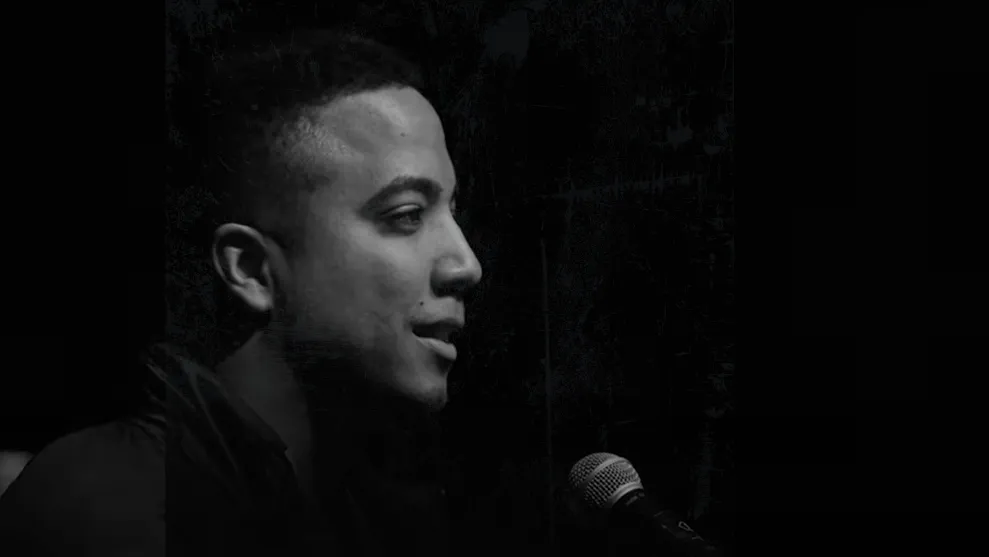 Kevin Jacobs standing in front of a microphone