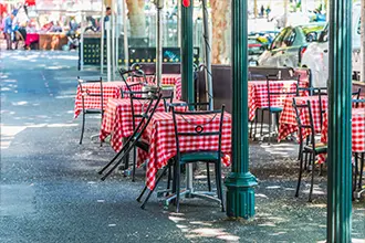 tables and chairs on lygon street in connection with carltons history