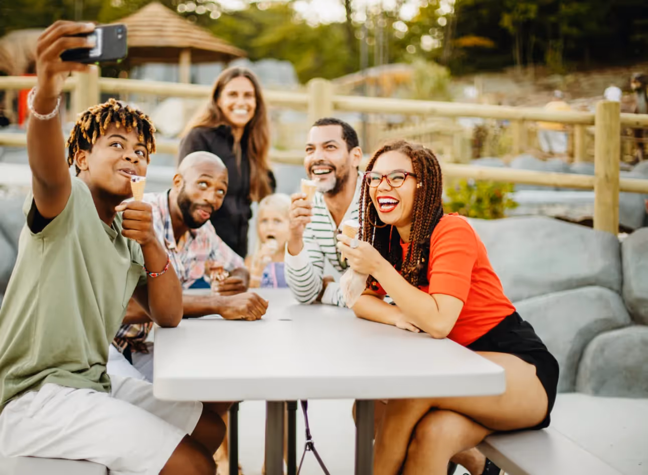 friends posing for picture with ice cream at golf course stock image