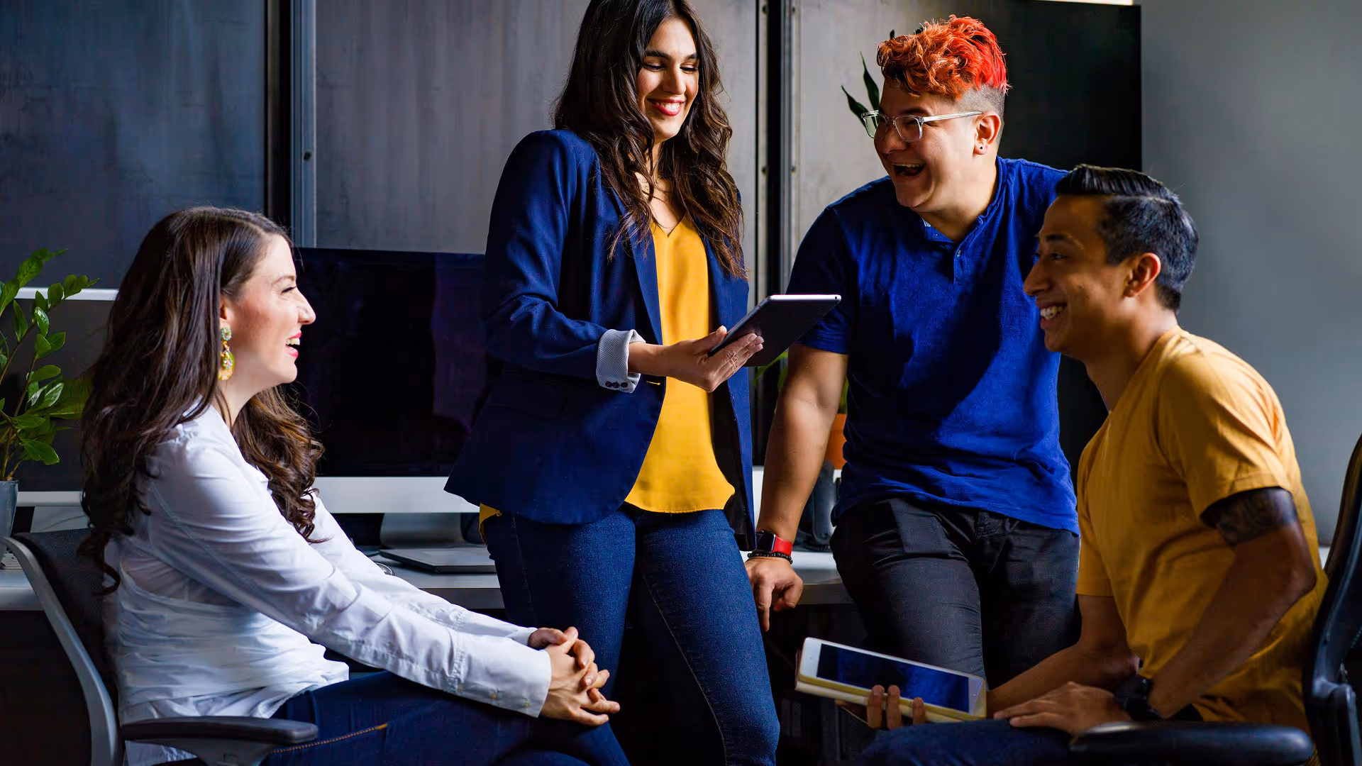 A joyful image of a group of people in an office room