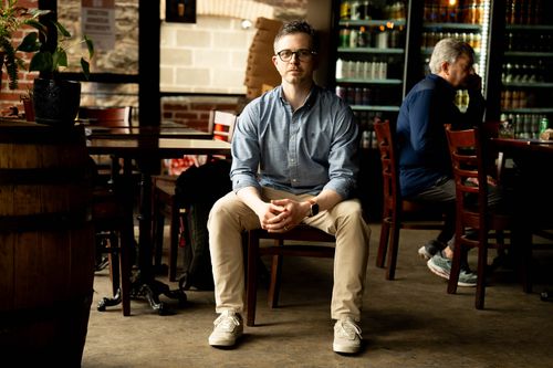 subject/scene: focused nutrition coach looking directly at camera