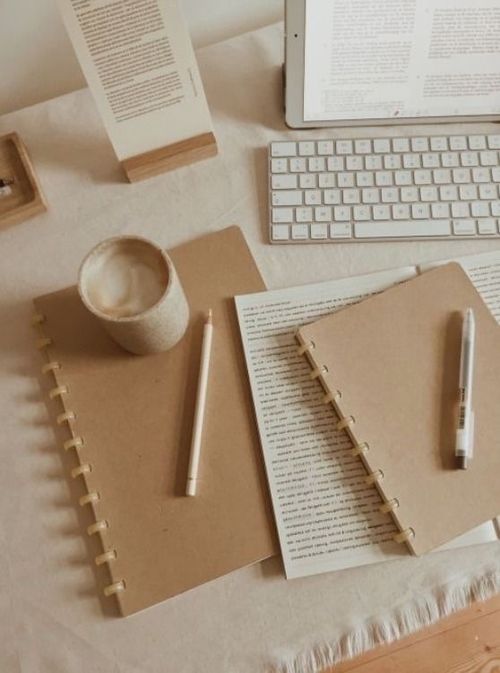 a table with coffee, diary, pen and paper